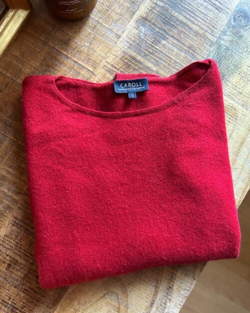 Secondhand Cashmere Pullover in Rot von Caroll. Zusammengefaltet auf Holztisch.