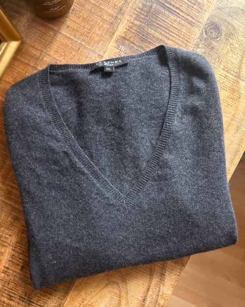 In Linea Firenze grauer preloved Cashmere Pullover mit V-Neck, gefaltet auf Holztisch.