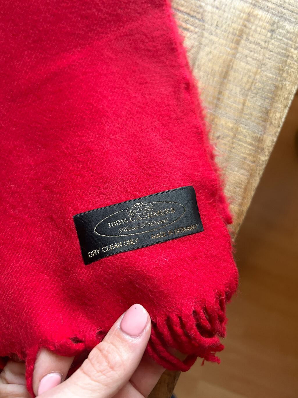 Monkky preloved Kaschmir Schal in Rot. Handgefertigt in Deutschland, gefaltet auf Holztisch.